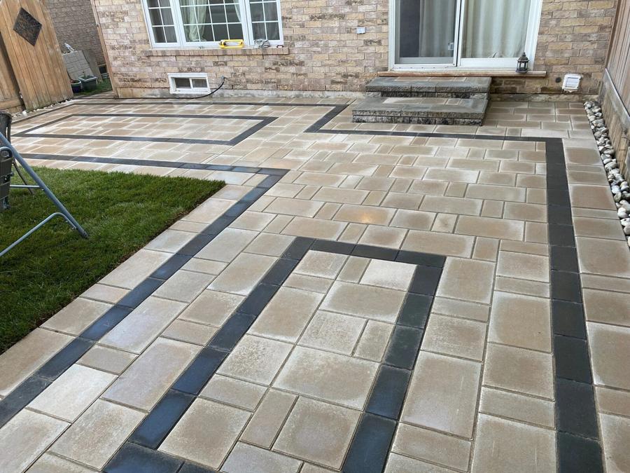 Interlock paver walkway and front patio with a dark banded border