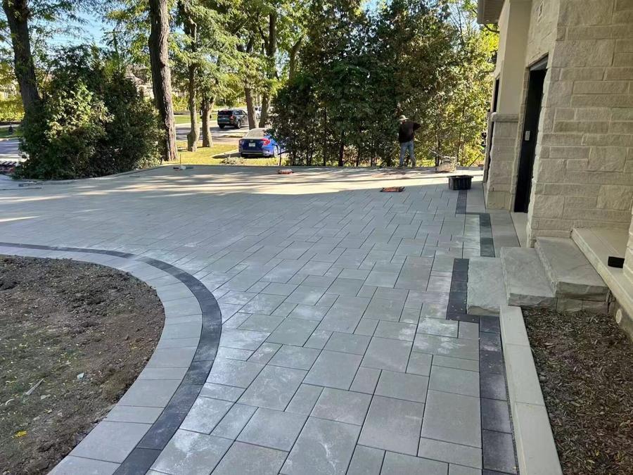 Curved interlock driveway with a dark banded border