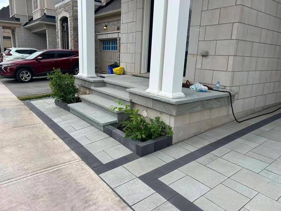 Front porch with stone columns, steps and paver landing