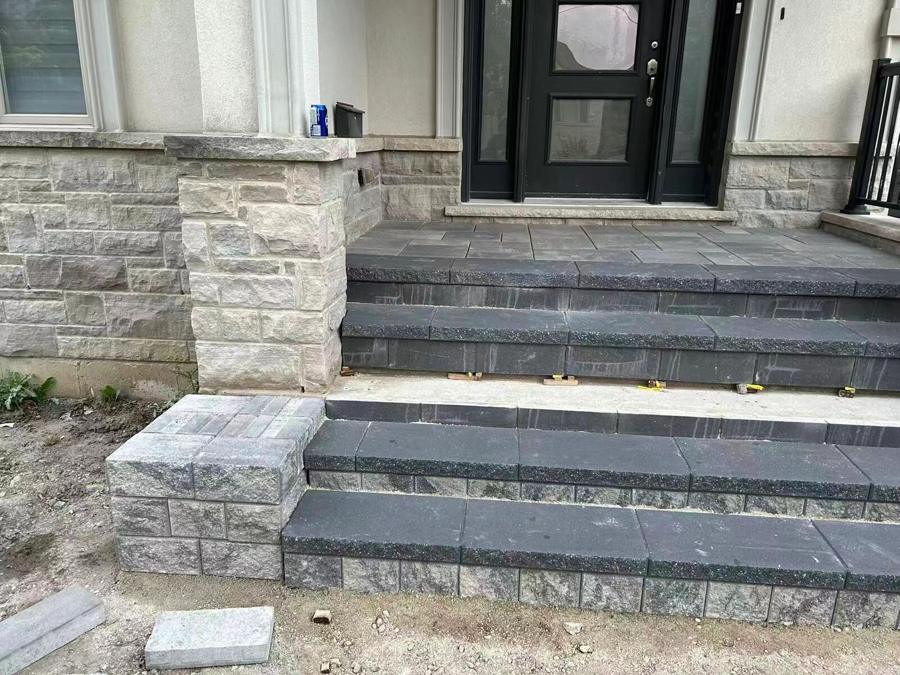 Stone entrance steps flanked by a natural stone wall