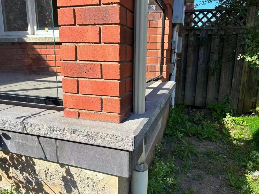 Stone step and coping detail against red brick
