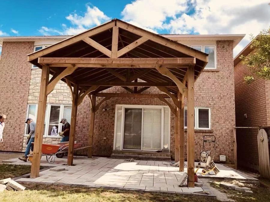 Cedar gazebo structure in a backyard