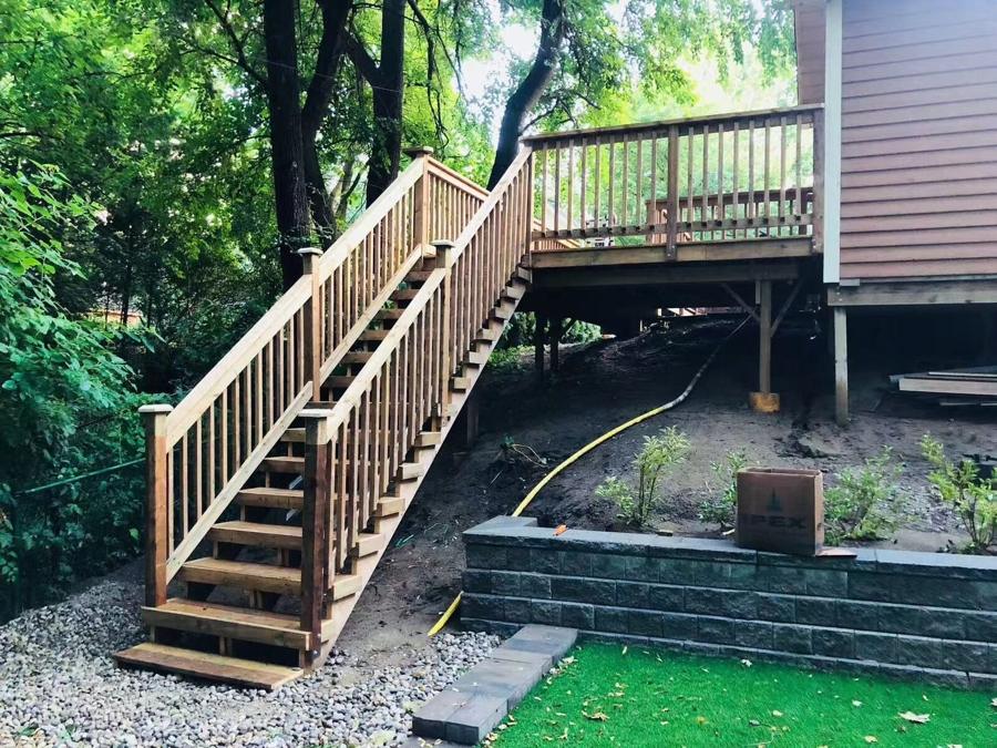 Cedar deck and staircase built over a retaining wall