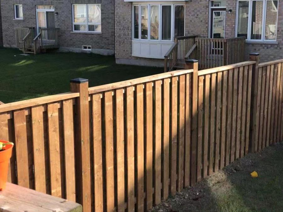 Wood privacy fence running down a side yard