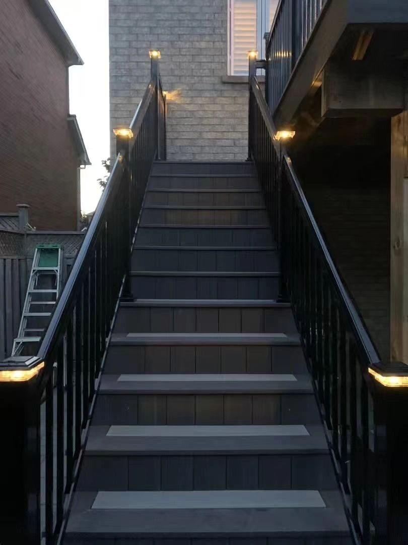 Exterior staircase with lit steps at dusk