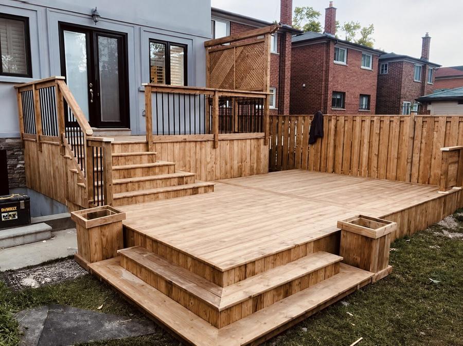 Wood deck with broad corner steps, planter boxes and an upper landing